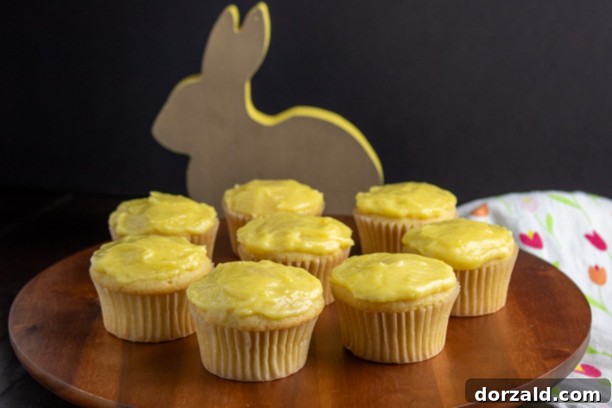 A batch of lemon cupcakes cooling on a wire rack