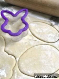 Close-up of lemon shortbread dough being cut with a cookie cutter