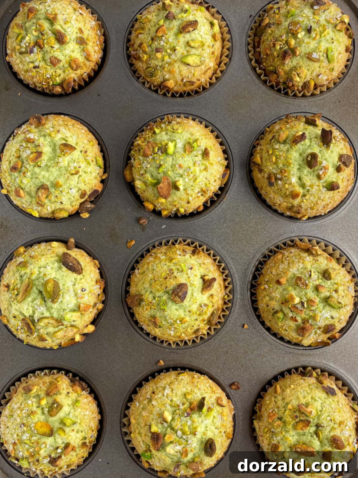 Close-up of baked dairy-free pistachio muffins in a muffin tin