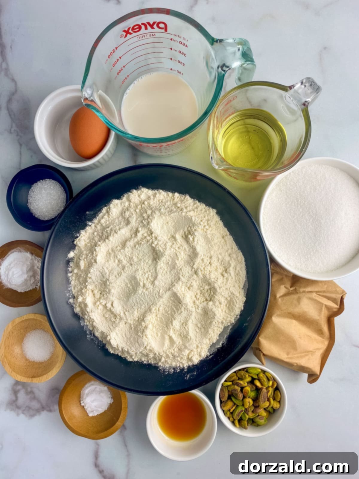 Graphic showing dry ingredients being mixed for dairy-free pistachio muffins