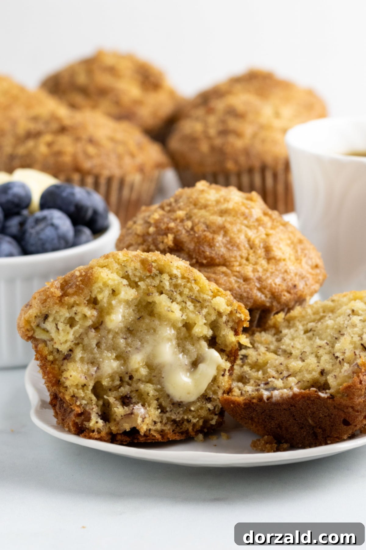 Freshly baked dairy-free banana muffins on a cooling rack, showing the brown sugar crunch topping.