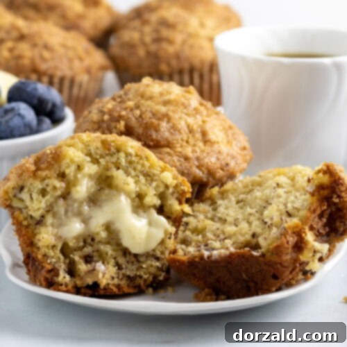 Close-up of a stack of three dairy-free banana muffins with brown sugar topping.