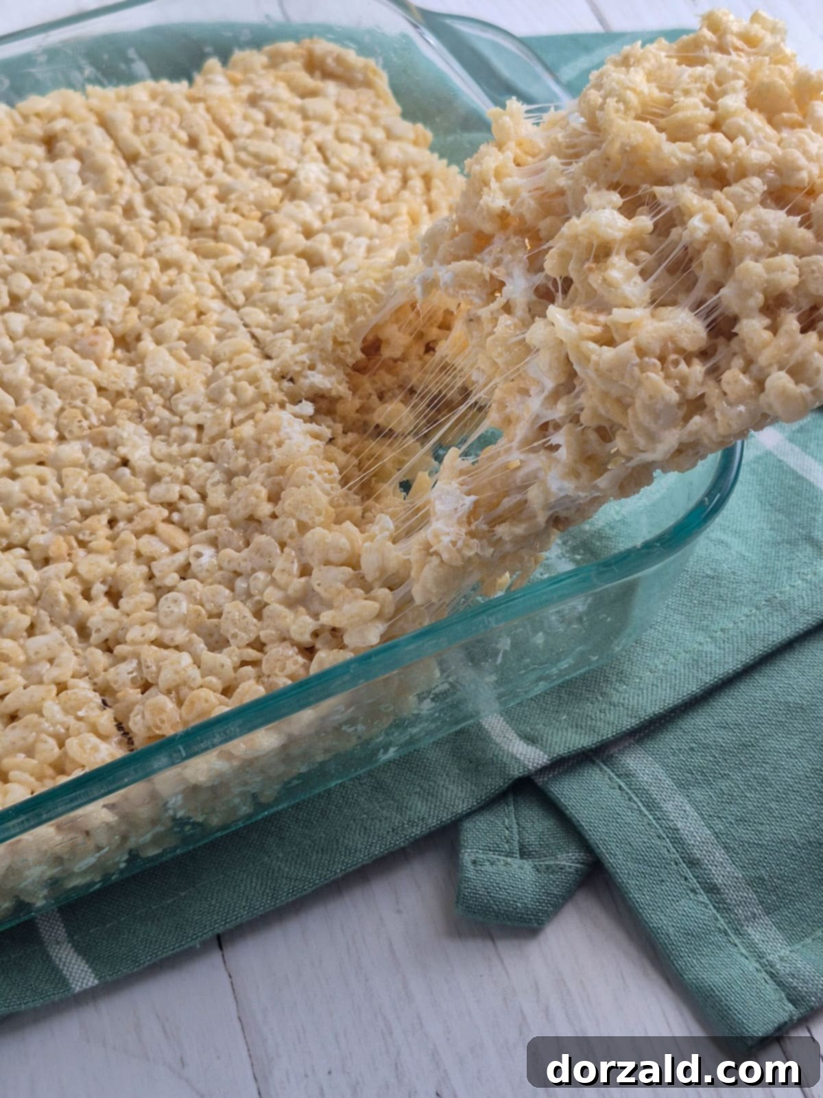 Gooey Dairy-Free Crispy Bites 6 Dairy-Free Rice Krispie Treats cut into squares in a pan