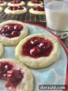 Freshly baked cherry lime cookies cooling on a rack