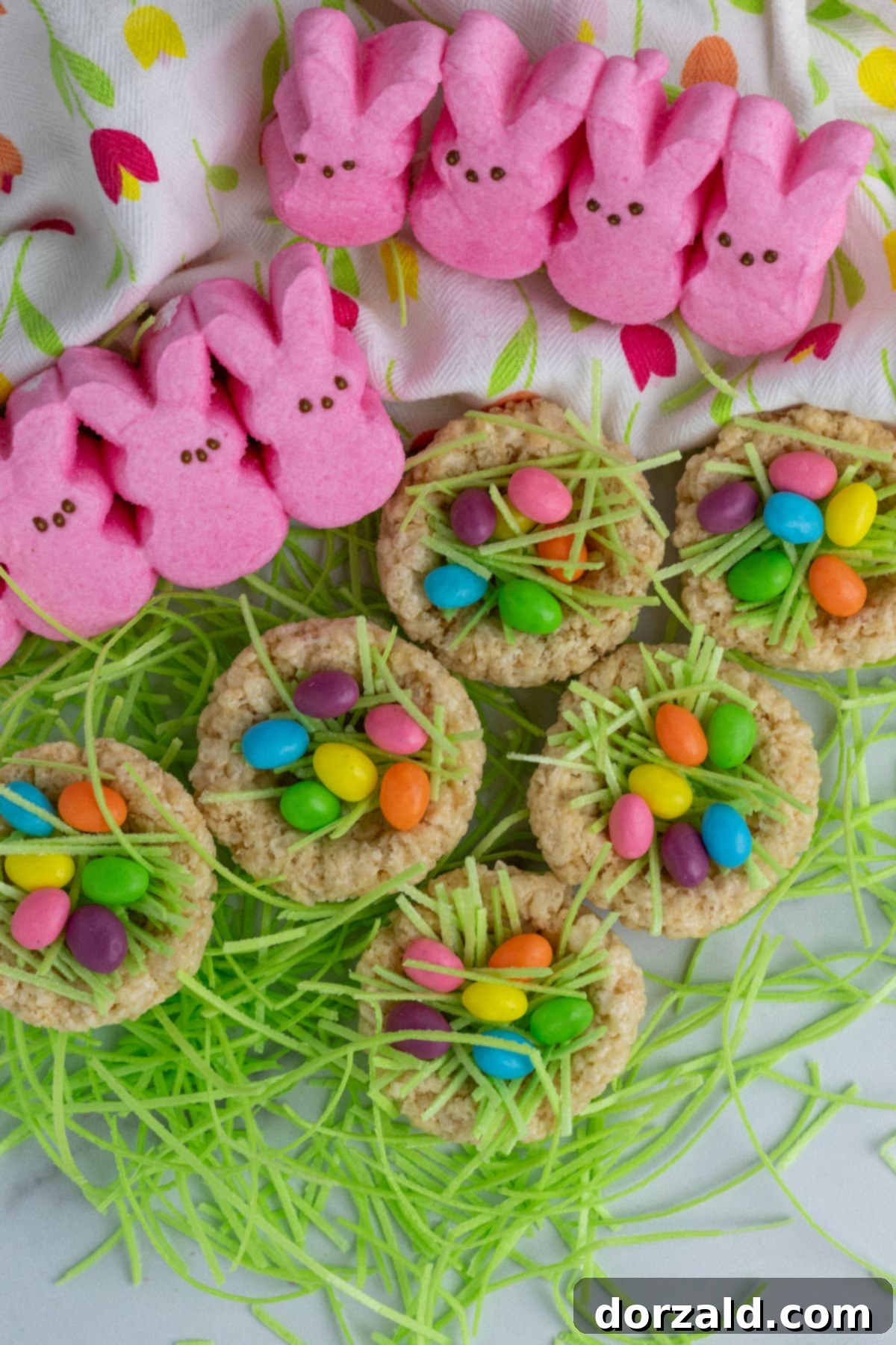 Easy Rice Krispie Easter Nests 6 A close-up of a Rice Krispie Easter Nest with colorful jelly beans on green edible grass, ready to be eaten.