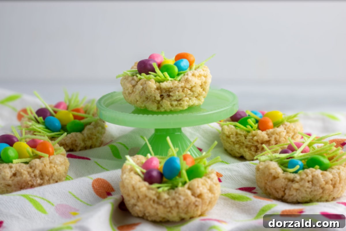 Easy Rice Krispie Easter Nests 7 A charming close-up of a Rice Krispie Easter Nest on a wooden surface, ready to be enjoyed.