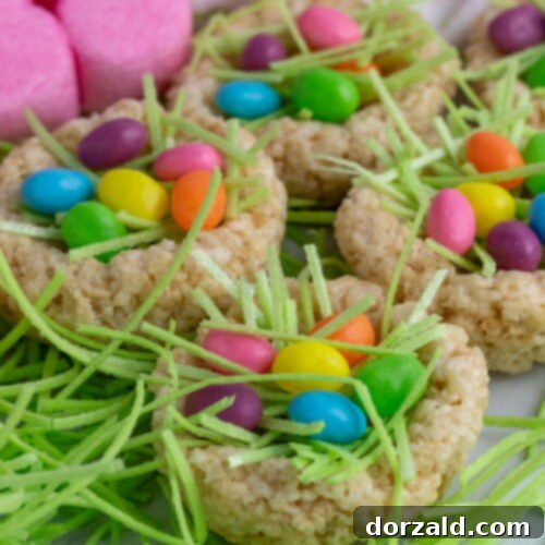 Easy Rice Krispie Easter Nests 8 rice krispie easter nests with pink marshmallow bunnies in the background