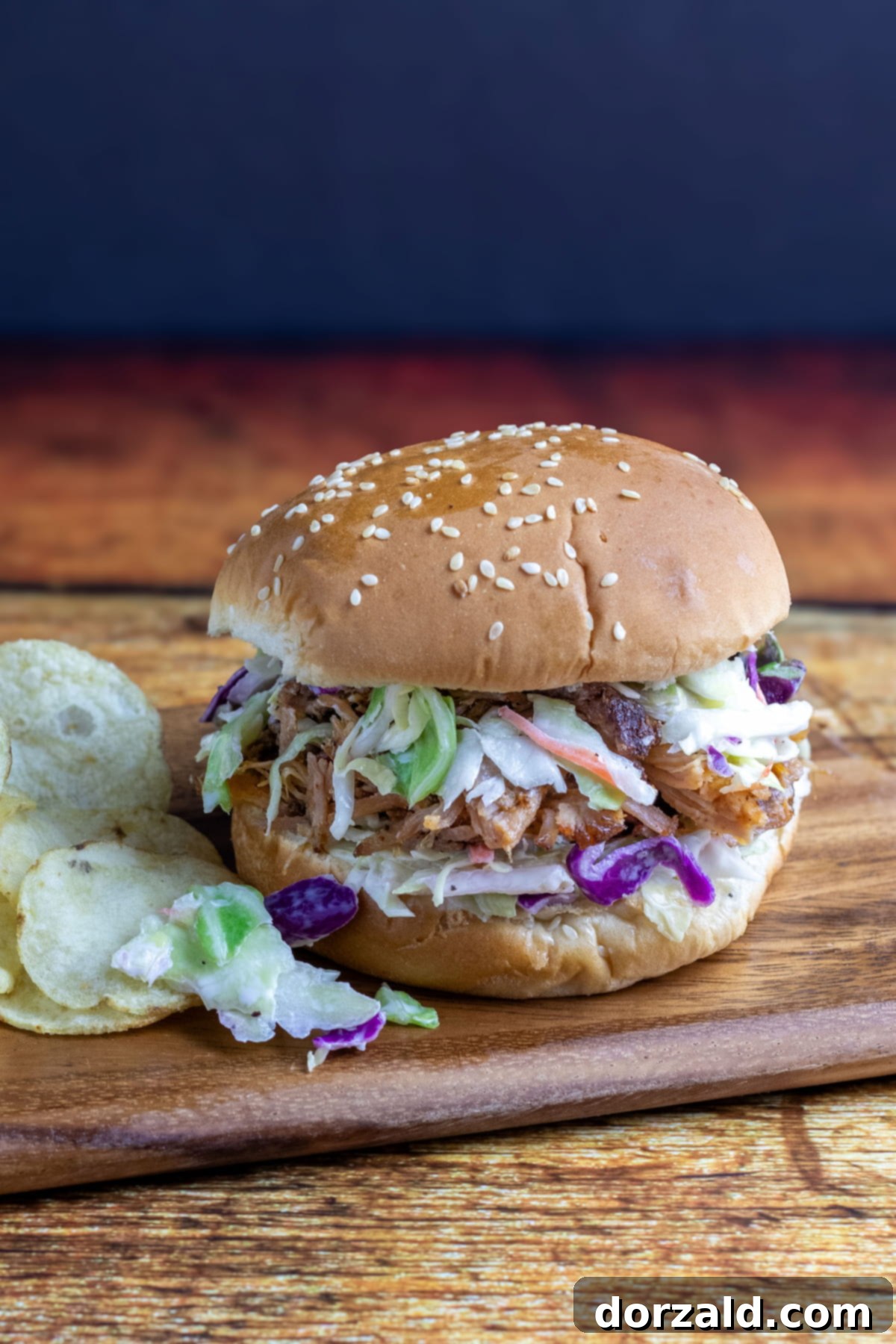 Smoked Pulled Pork and Creamy Slaw Sandwich 2 A close-up shot of a perfectly assembled Pulled Pork Coleslaw Sandwich, showcasing the tender pork, creamy coleslaw, and a soft sesame bun.