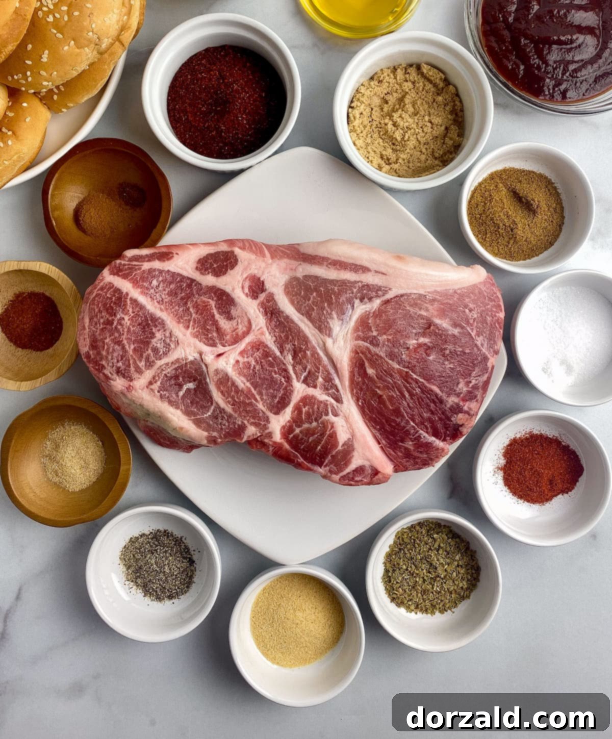 Smoked Pulled Pork and Creamy Slaw Sandwich 4 A bowl of the homemade spice rub, a pork roast, and a variety of fresh spices, ready for making pulled pork.