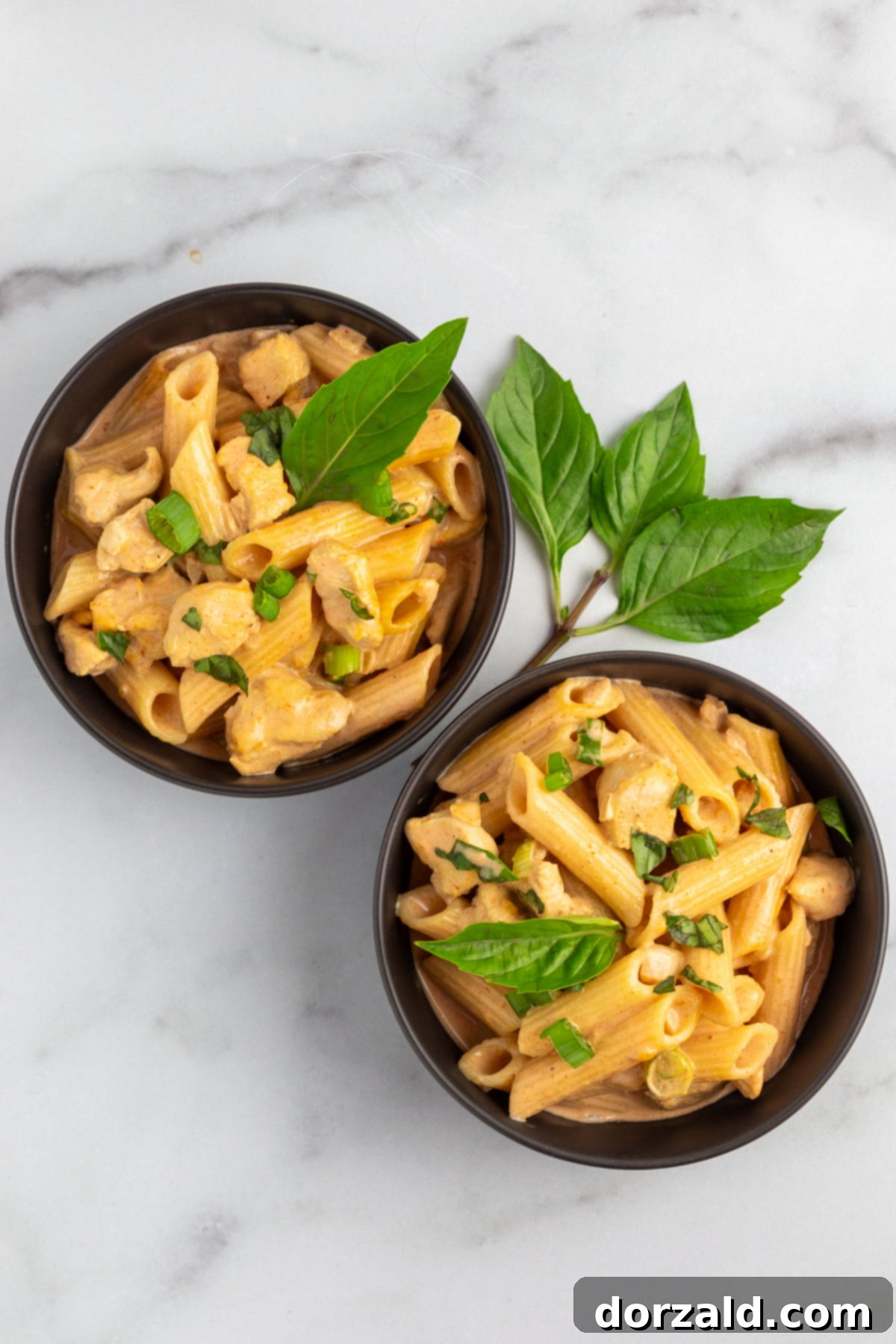 Creamy Chicken Curry Pasta 3 A wide shot of a skillet filled with creamy Chicken Curry Pasta, showing the rich texture and vibrant colors before serving.