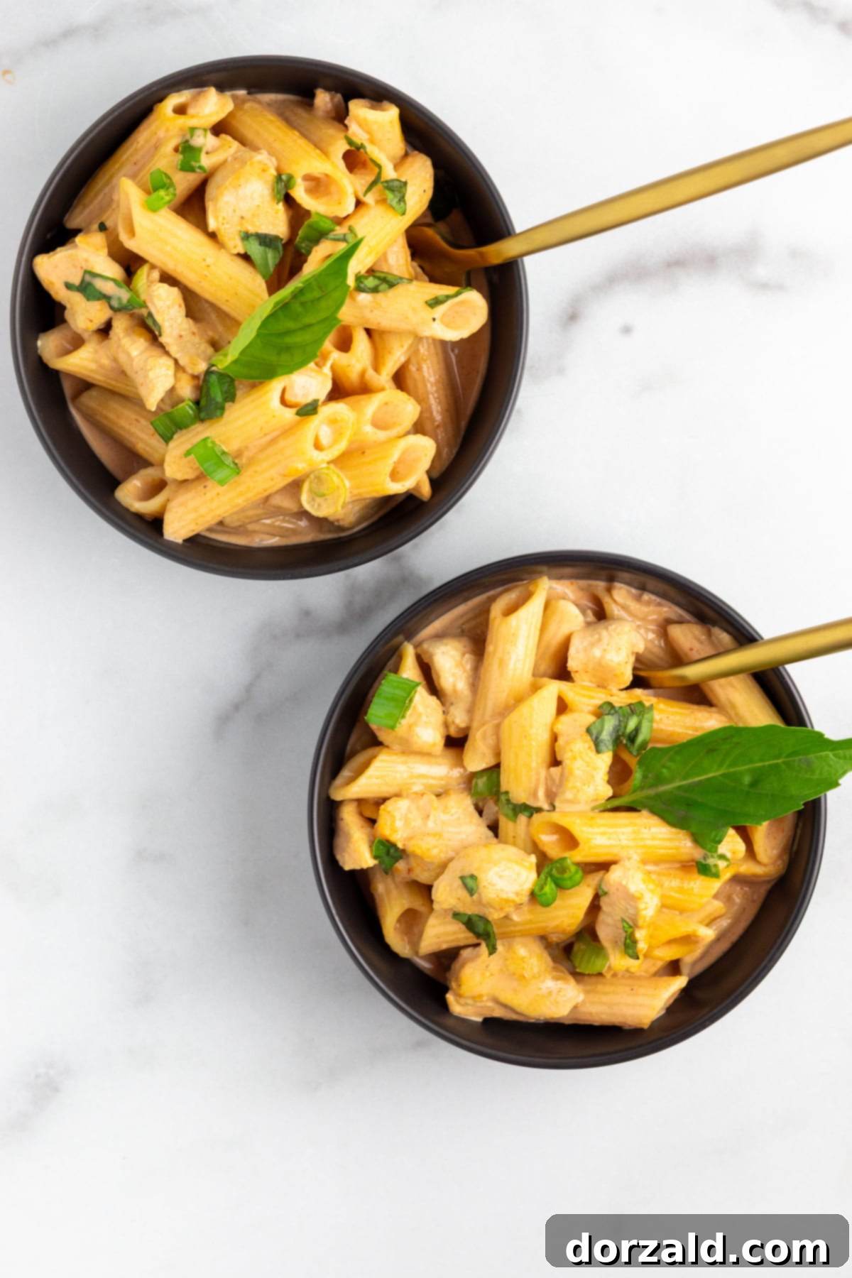Creamy Chicken Curry Pasta 7 An overhead view of the finished Chicken Curry Pasta in a serving bowl, showcasing its rich texture and garnishes.