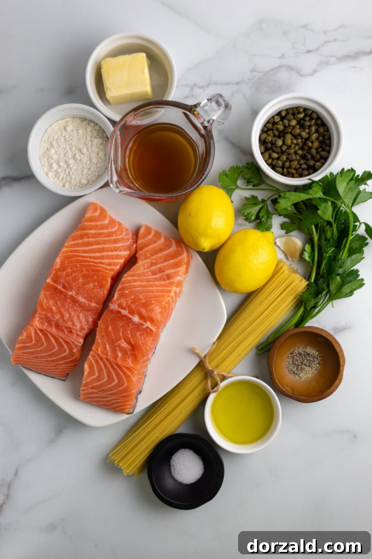 Salmon fillets being dusted with flour, salt, and pepper in a shallow bowl before cooking.