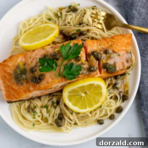 A close-up image of the finished Salmon Piccata Pasta, showcasing the flaky salmon and rich sauce.