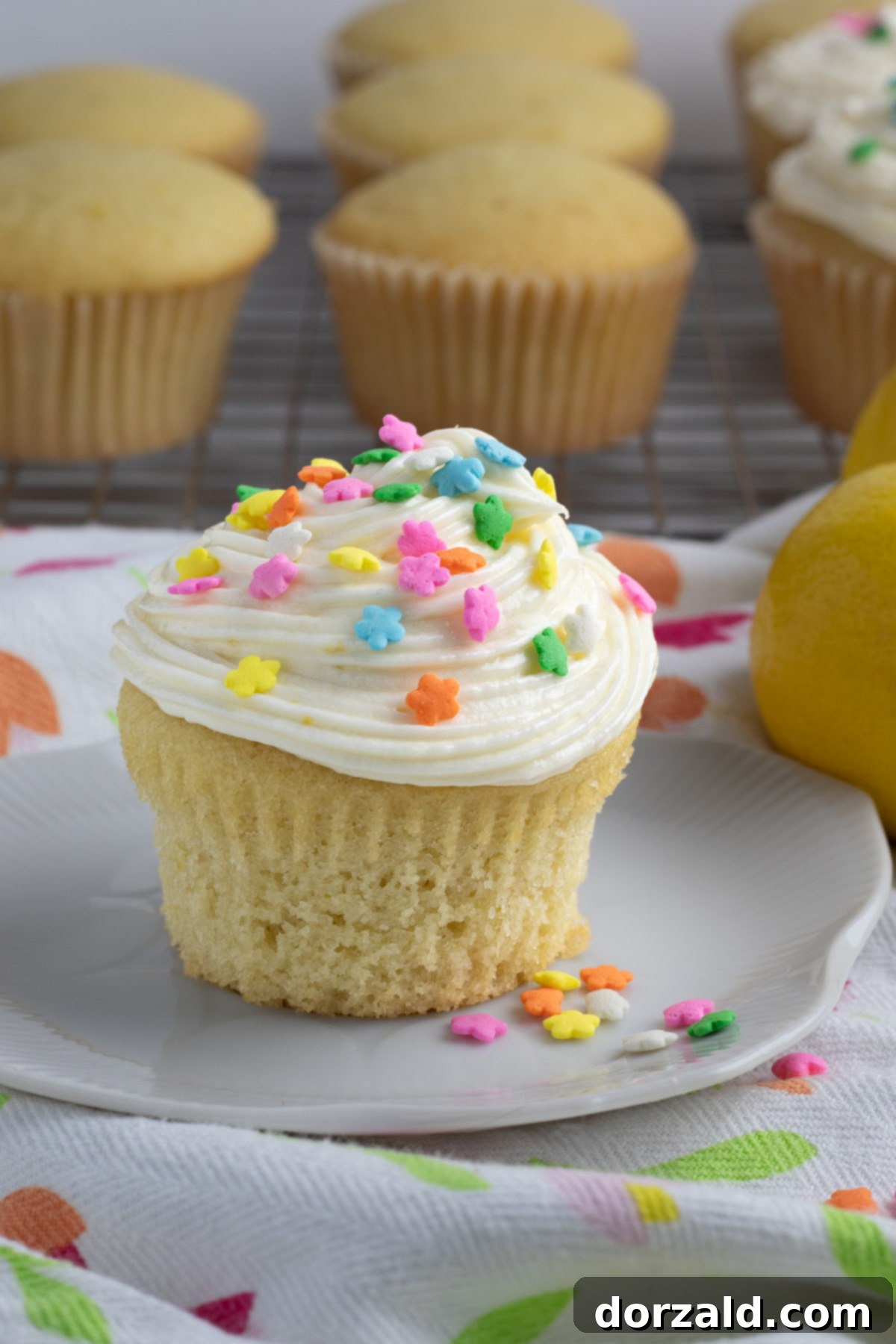 Freshly grated lemon zest and squeezed lemon juice in small bowls, ready to be incorporated into the cupcake batter.