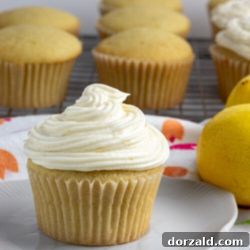 A stack of golden, freshly baked dairy-free lemon cupcakes.