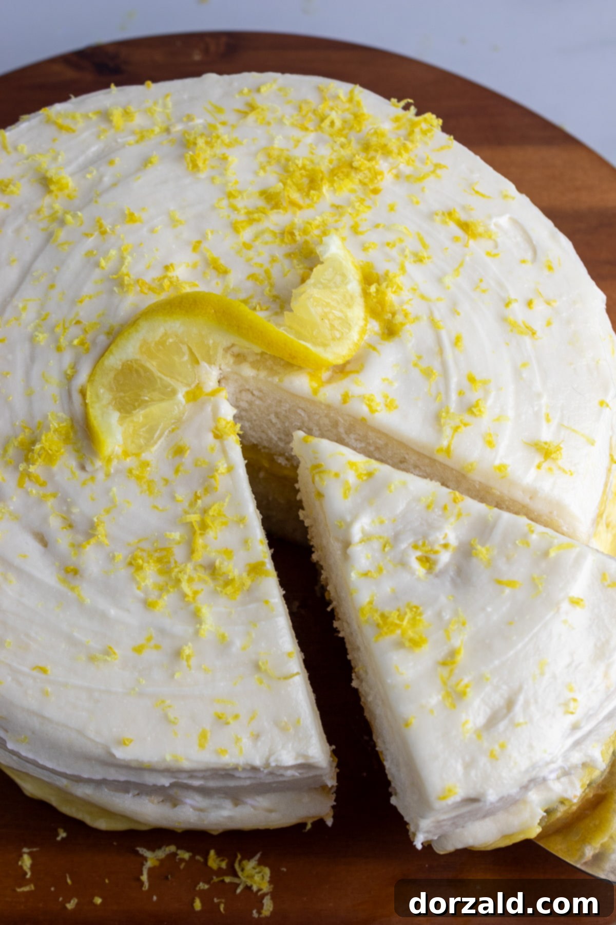 Finished vegan lemon frosting being scooped into a piping bag