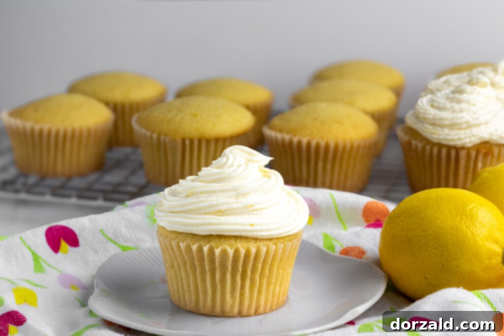 A beautifully frosted vegan lemon cupcake with a swirl of vegan lemon frosting