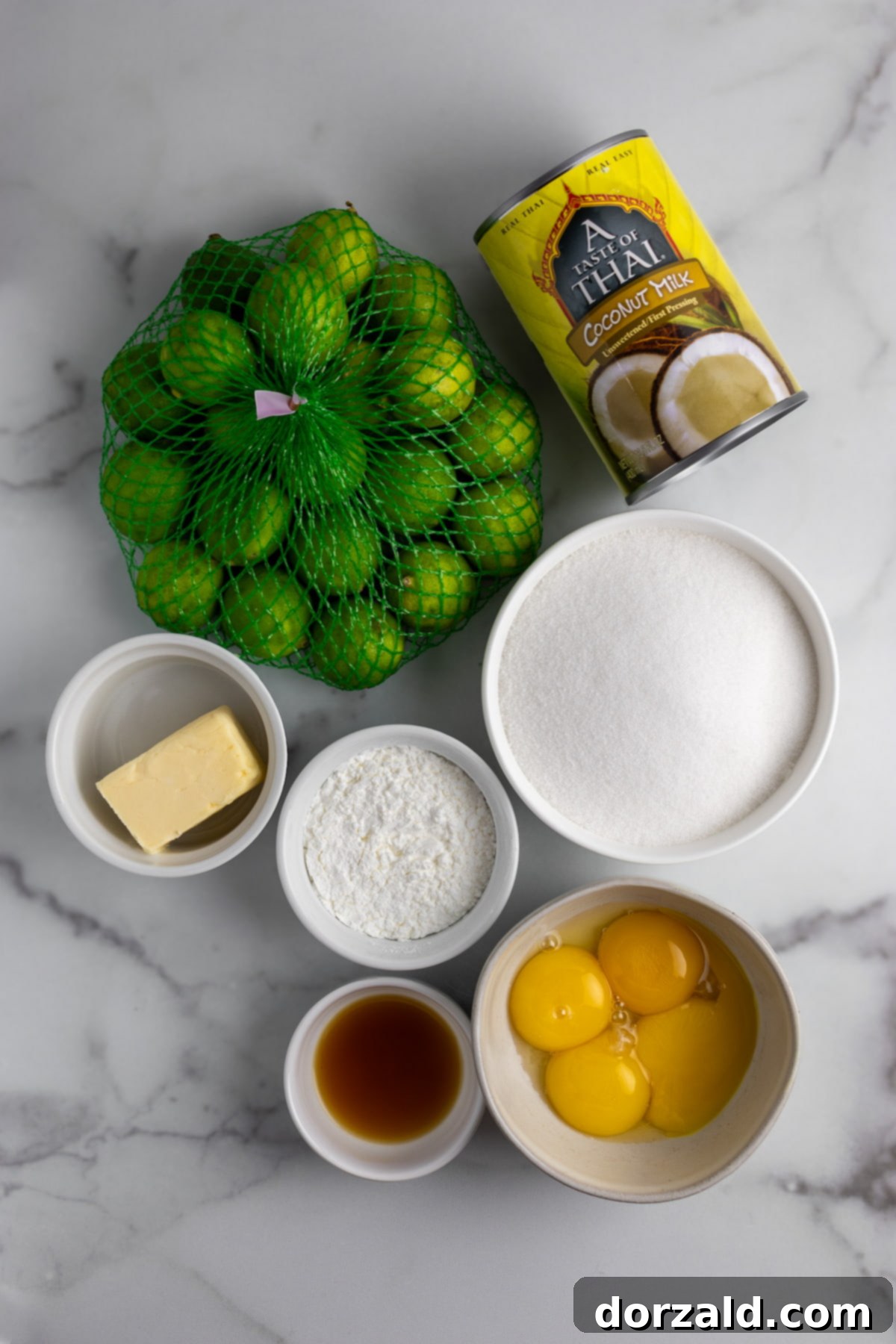 Close-up of fresh key limes, zest, and egg yolks, ready for making the key lime pie filling.