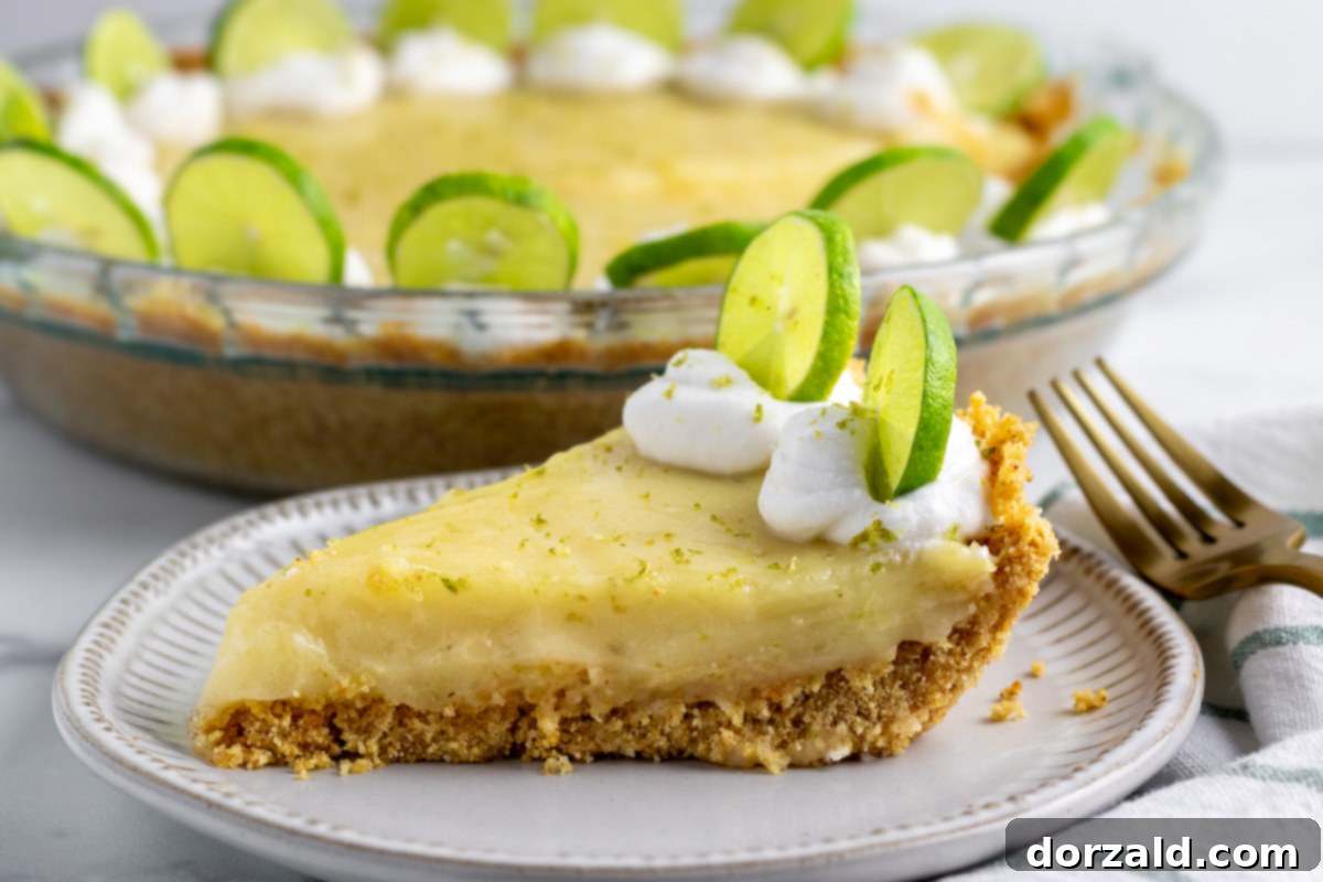 A beautifully set gluten-free dairy-free key lime pie in a pie dish, ready for slicing.