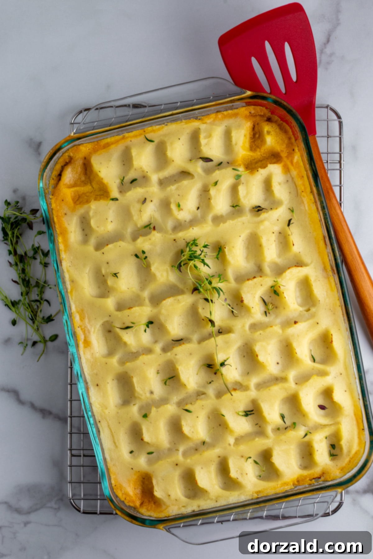 A beautifully baked Dairy-Free Shepherd's Pie with golden brown mashed potato peaks in a casserole dish, ready to be served.