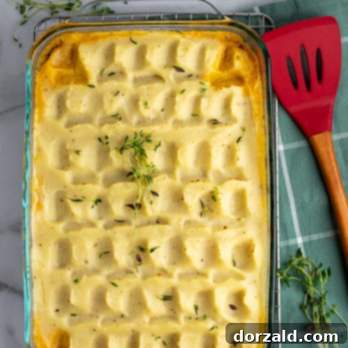 A delicious slice of Dairy-Free Shepherd's Pie on a plate, showing the layers of meat, vegetables, and creamy mashed potato topping.