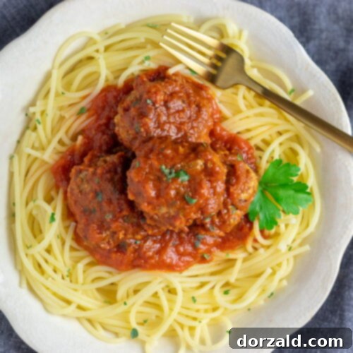Authentic Italian Gluten-Free Dairy-Free Meatballs 9 Gluten and Dairy Free Meatballs in a skillet with sauce