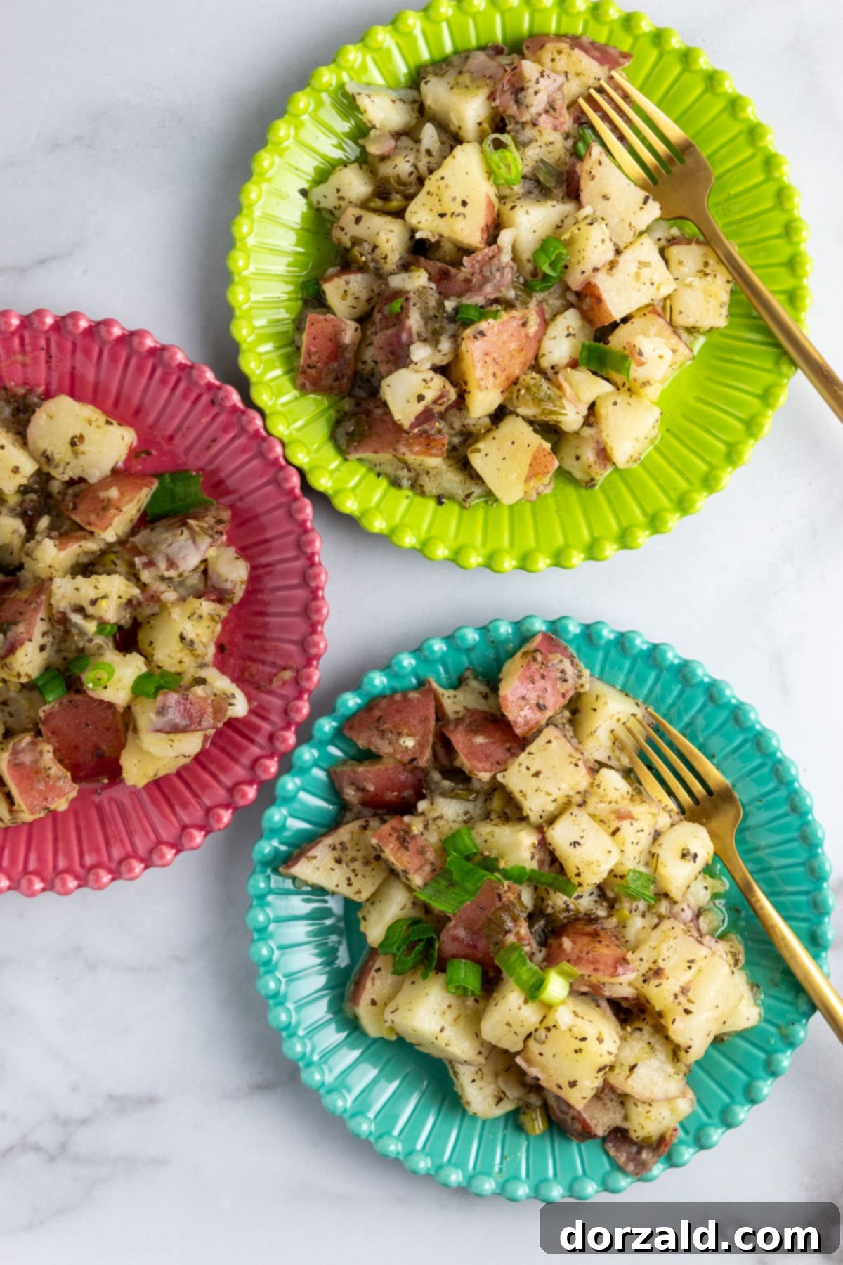 A vibrant bowl of Zoes Kitchen copycat grilled potato salad garnished with fresh green onions, sitting on a rustic wooden table.