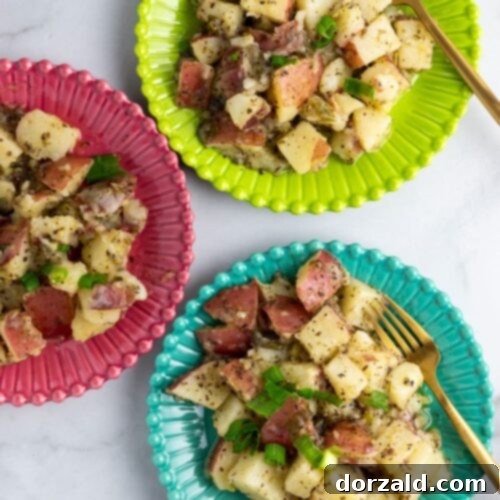 A close-up shot of grilled red potato salad with green onions.